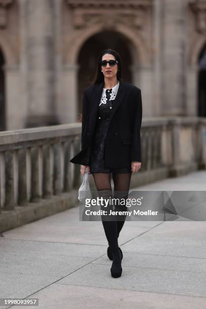 Sara Lazarevic seen wearing black sunglasses, silver diamond earrings, black elegant blazer jacket, black flower embroidered dress with a white lace...