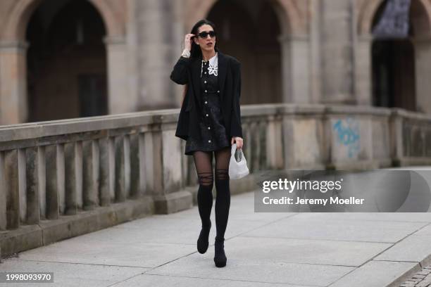 Sara Lazarevic seen wearing black sunglasses, silver diamond earrings, black elegant blazer jacket, black flower embroidered dress with a white lace...