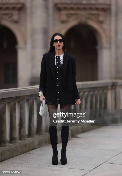 Sara Lazarevic seen wearing black sunglasses, silver diamond earrings, black elegant blazer jacket, black flower embroidered dress with a white lace...