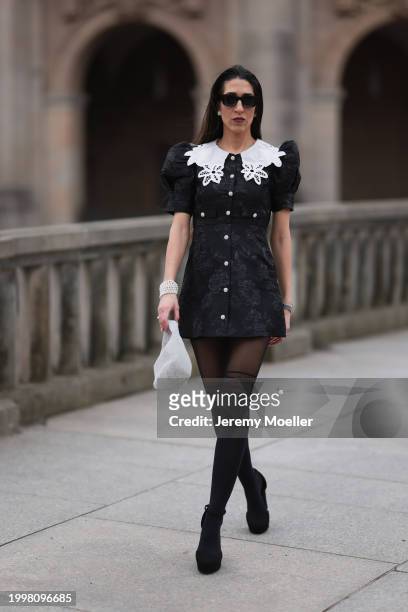 Sara Lazarevic seen wearing black sunglasses, silver diamond earrings, black flower embroidered dress with a white lace collar and puff sleeves,...