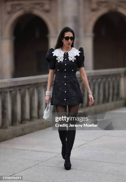 Sara Lazarevic seen wearing black sunglasses, silver diamond earrings, black flower embroidered dress with a white lace collar and puff sleeves,...