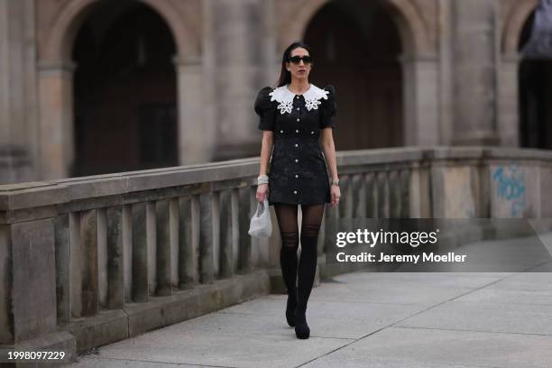 Sara Lazarevic seen wearing black sunglasses, silver diamond earrings, black flower embroidered dress with a white lace collar and puff sleeves,...