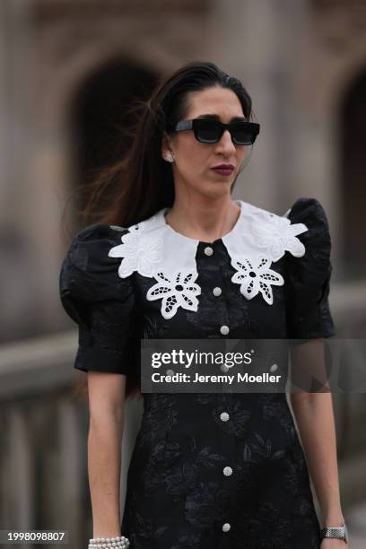 Sara Lazarevic seen wearing black sunglasses, silver diamond earrings, black flower embroidered dress with a white lace collar and puff sleeves, on...