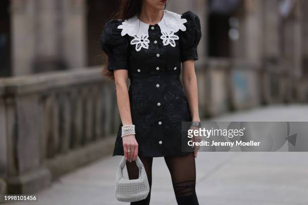 Sara Lazarevic seen wearing black flower embroidered dress with a white lace collar and puff sleeves, black tights, white pearl bracelets, silver...