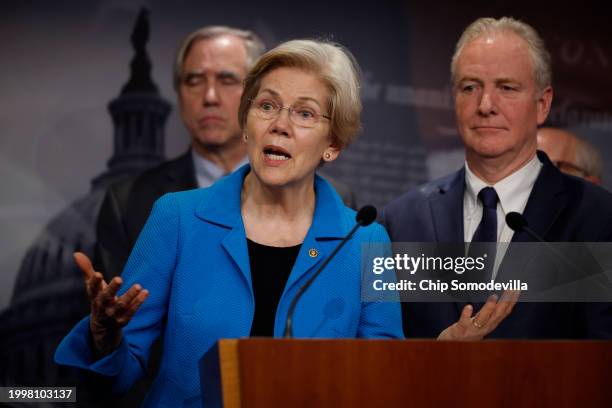 Sen. Elizabeth Warren talks to reporters with Sen. Jeff Merkley , Sen. Chris Van Hollen and fellow Senate Democrats during a news conference at the...