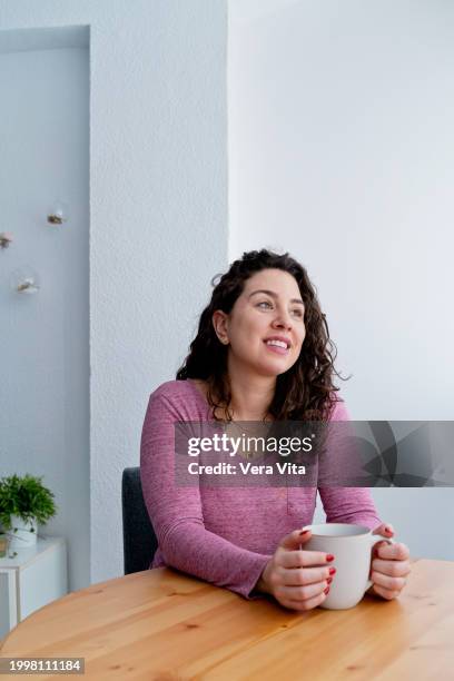 cheerful spanish woman smiling drinking coffe at confortable decorated cozy bedroom - confortable imagens e fotografias de stock