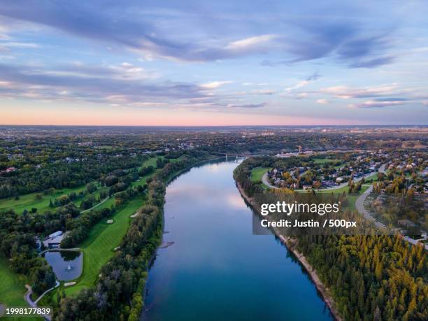 high angle view of river amidst buildings against sky,edmonton,alberta,canada - edmonton stock pictures, royalty-free photos & images