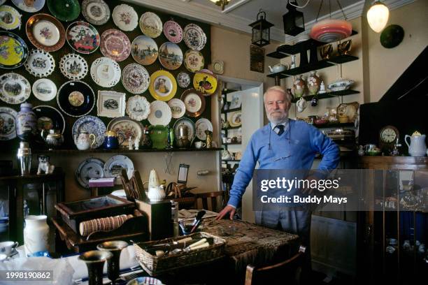 An antique dealer in one of many fine antique shops on Kensington Street in London, England,1995. .