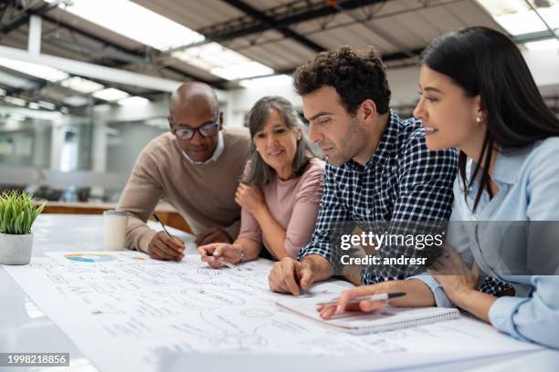 group of coworkers brainstorming at a coworking office - master of business administration stockfoto's en -beelden