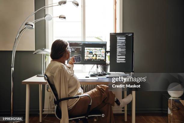 businesswoman with disability having coffee while doing video call on computer at home office - active lifestyle icons stock pictures, royalty-free photos & images