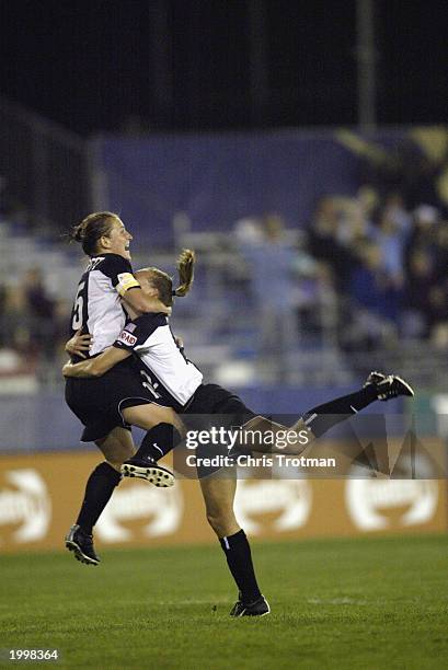 Tiffany Milbrett hugs the winning goal scorer Krista Davey of the New York Power as she scored in the 89th minute against the Boston Breakers at...