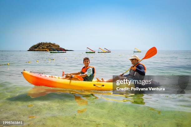 family canoeing at praia do creiro - portuguese culture stock pictures, royalty-free photos & images