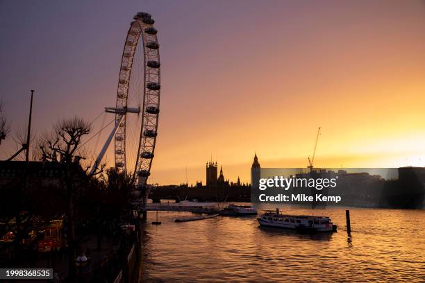 View looking across the River Thames at sunset towards the Houses of Parliament, the Palace of Westminster and clock tower Big Ben on 10th February...