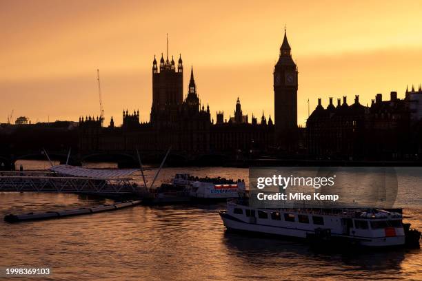 View looking across the River Thames at sunset towards the Houses of Parliament, the Palace of Westminster and clock tower Big Ben on 10th February...