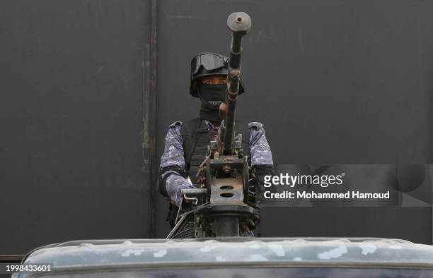 Security soldier mans a machine gun mounted on a police vehicle as Yemen's Houthi followers participate in a protest staged to show solidarity with...