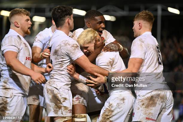 Archie McParland of England celebrates with his team mates after scoring his side's second try during the U20 Six Nations match between England and...