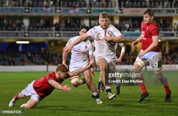 Craig Wright of England skips past Walker Price of Wales during the U20 Six Nations match between England and Wales at The Recreation Ground on...