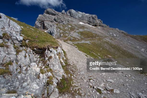 low angle view of rocks against sky - bernd dembkowski stock-fotos und bilder