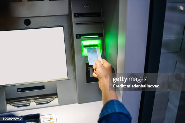 handsome mann mit atm-maschine - geldautomat stock-fotos und bilder