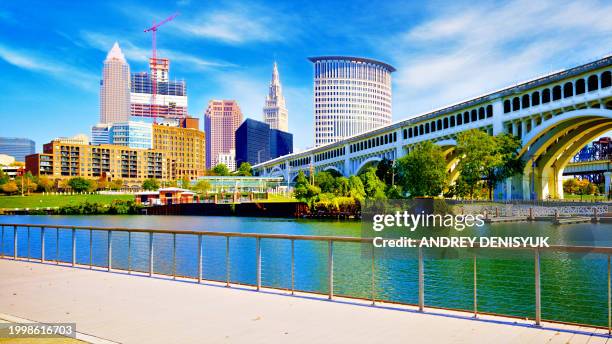 cleveland skyline. a view of the city from cuyahoga river. - cleveland ohio skyline stock pictures, royalty-free photos & images