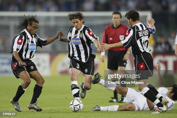 Alessio Tacchinardi of Juventus skips through a tackle with team mate Edgar Davids at hand during the UEFA Champions League semi final second leg...