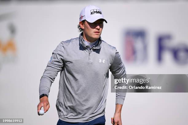Maverick McNealy of the United States waves on the 16th green during the continuation of the weather-delayed first round of the WM Phoenix Open at...