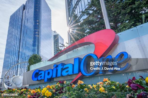 The sun flares over the top of the Capital One logo outside of their corporate headquarters complex on February 8 in McLean, Va.