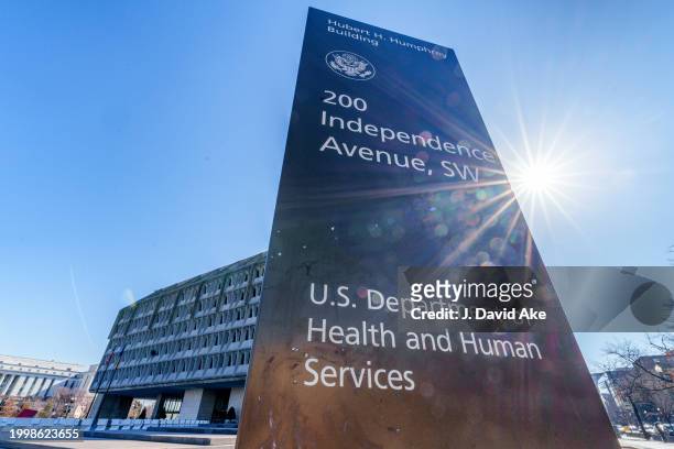 The sun flares next to the sign marking the headquarters building of the US Department of Health and Human Services on February 9 in Washington, DC.