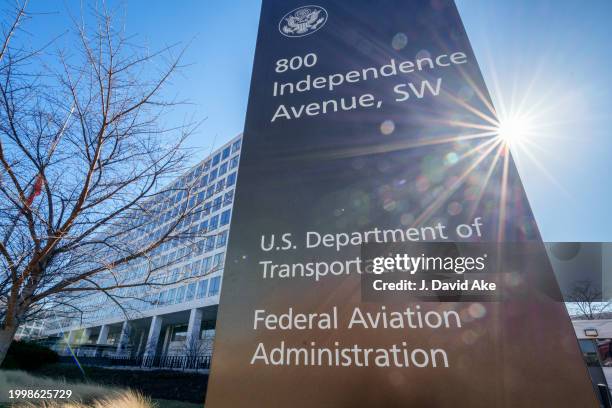 The sun flares next to the sign marking the location of the Federal Aviation Administration headquarters on February 9 in Washington, DC.