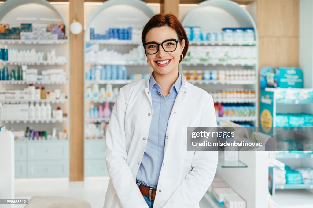 Happy female pharmacist at work
