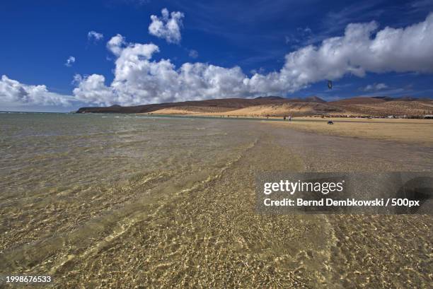 scenic view of beach against sky - bernd dembkowski stock-fotos und bilder