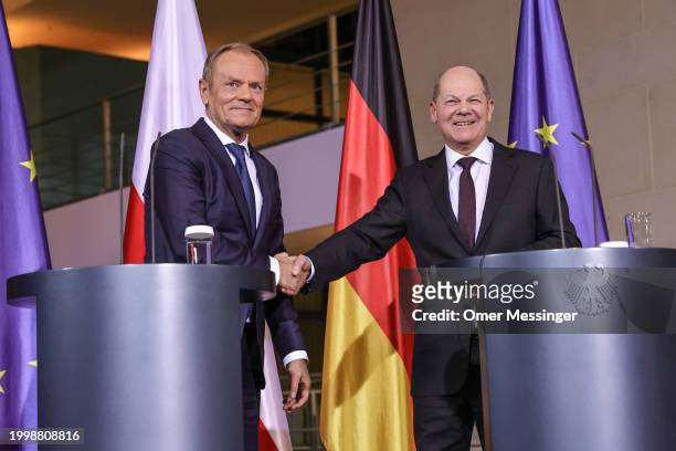 German Chancellor Olaf Scholz and Polish Prime Minister Donald Tusk shake hands following a joint press conference at the Chancellery on February 12,...