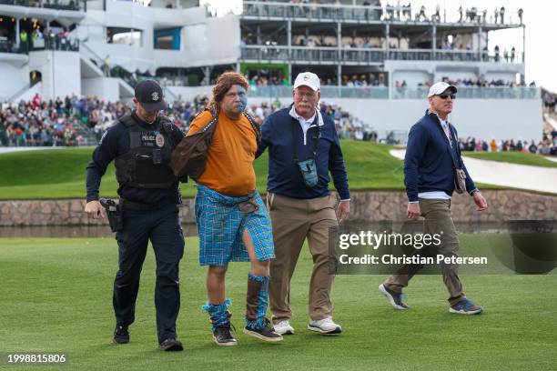 Fan dressed in costume as William Wallace from Braveheart, is apprehended by a police officer and staff after running on the 11th hole during the...