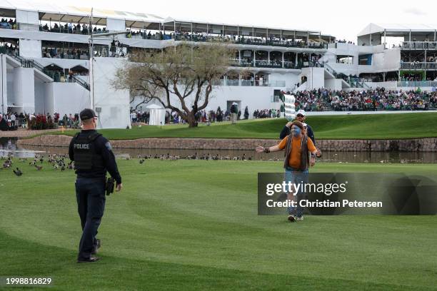 Fan dressed in costume as William Wallace from Braveheart, runs on the 11th hole during the second round of the WM Phoenix Open at TPC Scottsdale on...