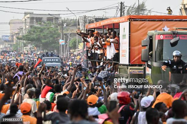 Ivory Coast players, winners of the 2024 African Cup of Nations , wave to the crowd as they parade on a truck through the popular district of...