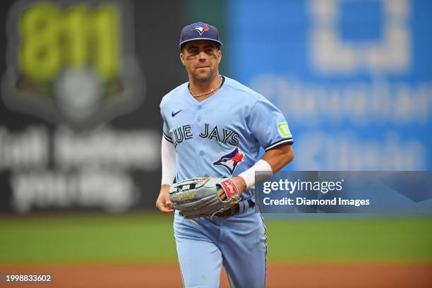 Whit Merrifield of the Toronto Blue Jays runs off the field after the third inning against the Cleveland Guardians at Progressive Field on August 9,...