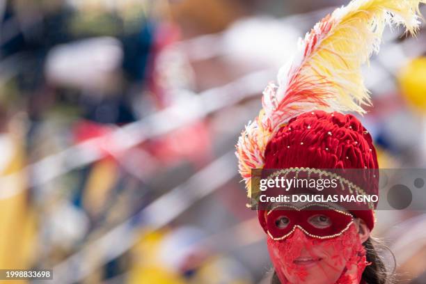 Reveler on horseback takes part in a traditional carnival parade in Bonfim, Minas Gerais State, Brazil, on February 12, 2024. Dressed in...