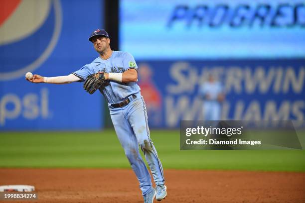 Whit Merrifield of the Toronto Blue Jays throws to first base during the eighth inning against the Cleveland Guardians at Progressive Field on August...