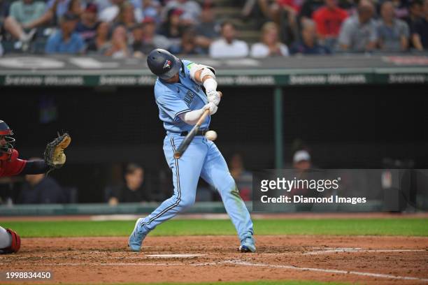 Whit Merrifield of the Toronto Blue Jays hits a single during the fifth inning against the Cleveland Guardians at Progressive Field on August 9, 2023...