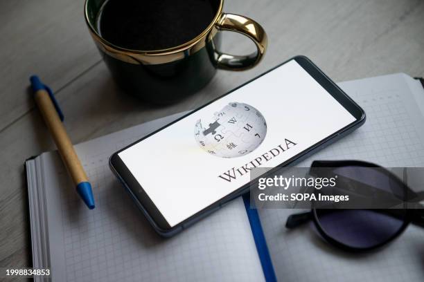 In this photo illustration a Wikipedia logo seen displayed on a smartphone.