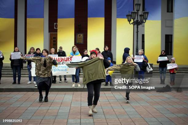 Protesters stage a short performance with jackets of the Ukrainian Armed Forces, with an aim to attract the attention of others on Dumskaya Square...