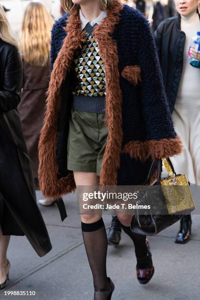 Blue and brown coats with green shorts and yellow bag outside the Helmut Lang show during New York Fashion Week at Weylin on February 09, 2024 in New...