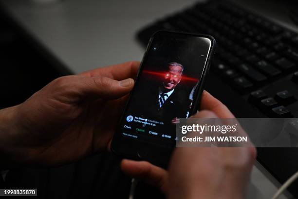 In this photo illustration, a reporter shows US President Joe Biden's X account on their phone at the White House on February 12, 2024 in Washington,...
