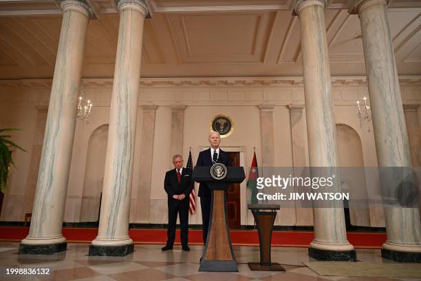 King Abdullah II of Jordan looks on as US President Joe Biden speaks to the press in the Cross Hall of the White House in Washington, DC, on February...