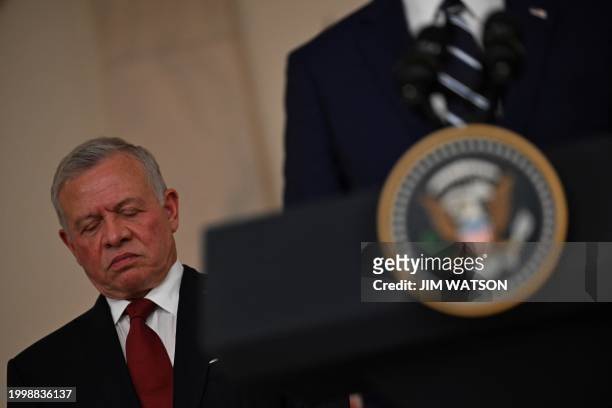 King Abdullah II of Jordan looks on as US President Joe Biden speaks to the press in the Cross Hall of the White House in Washington, DC, on February...