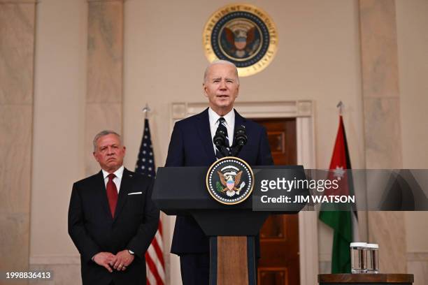 President Joe Biden speaks as King Abdullah II of Jordan listens in the Cross Hall of the White House in Washington, DC, on February 12, 2024. The...