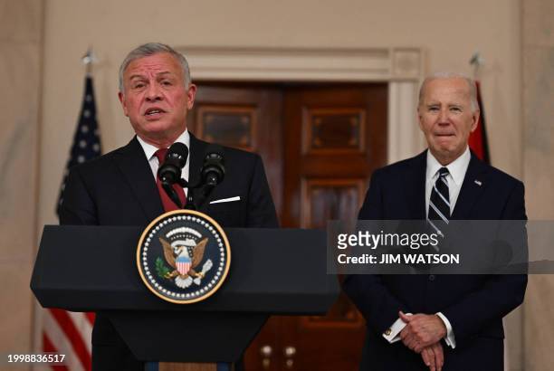 King Abdullah II of Jordan speaks to the press as US President Joe Biden looks on in the Cross Hall of the White House in Washington, DC, on February...