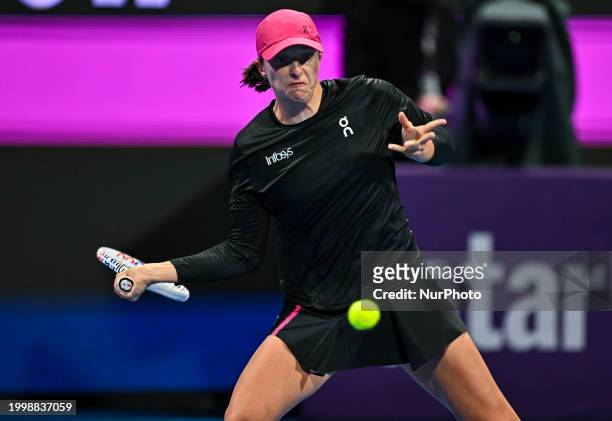 Iga Swiatek of Poland is playing in her second-round match against Sorana Cirstea of Romania at the WTA 1000-Qatar TotalEnergies Open tennis...