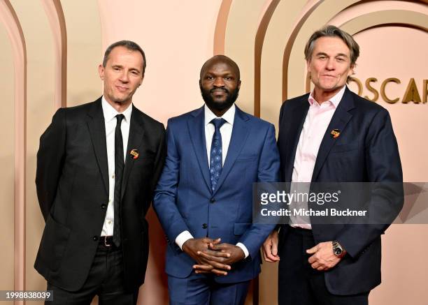 John Battsek, Moses Bwayo and Christopher Sharp at the 96th Oscars Nominee Luncheon at the Beverly Hilton on February 12, 2024 in Beverly Hills,...