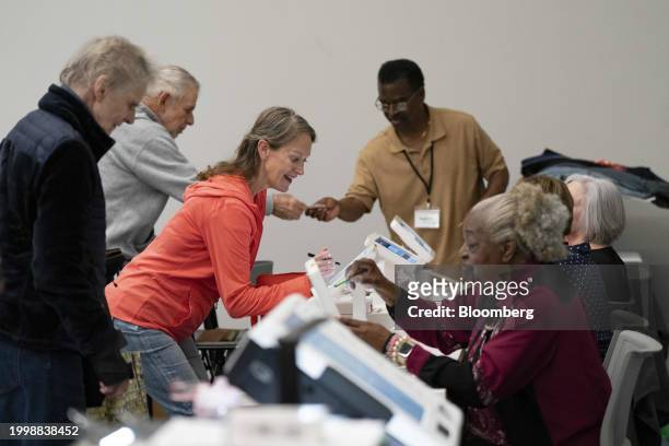 Voters check in to vote during the first day of early voting at a polling station in Mount Pleasant, South Carolina, US, on Monday, Feb. 12, 2024....